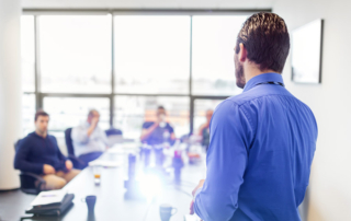 Photo of a person leading a business meeting